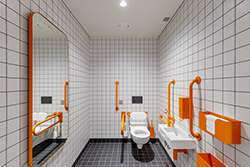 Burnt orange colour scheme on commercial washroom products